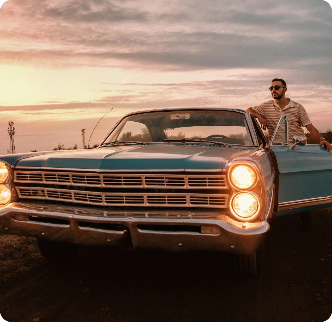 Classic car at sunset with driver